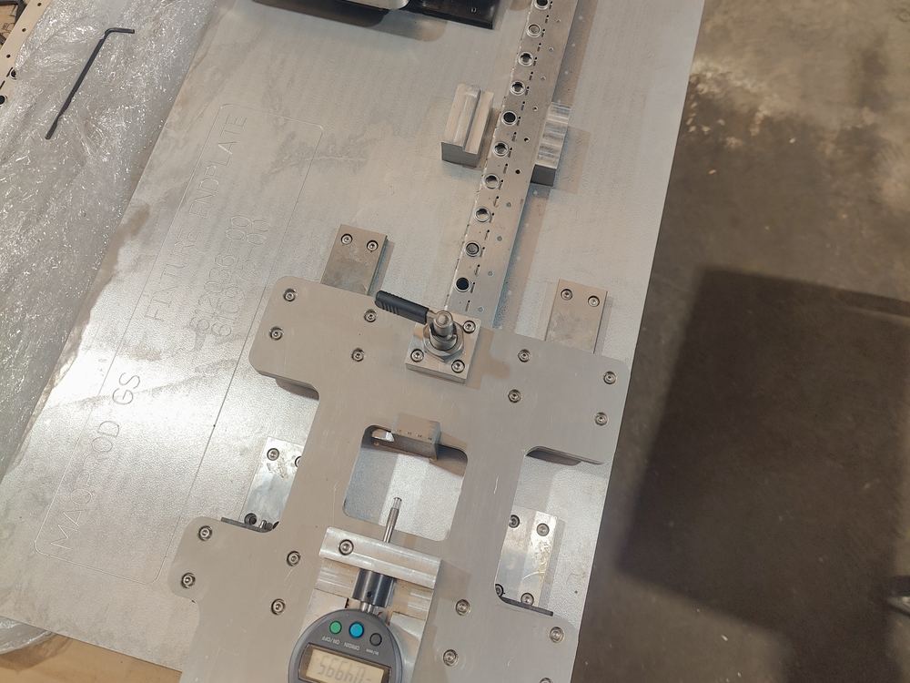 Fixture de medición de aluminio con localizadores, clamps e indicador digital montado, grabado MAQPROD GS y número de parte