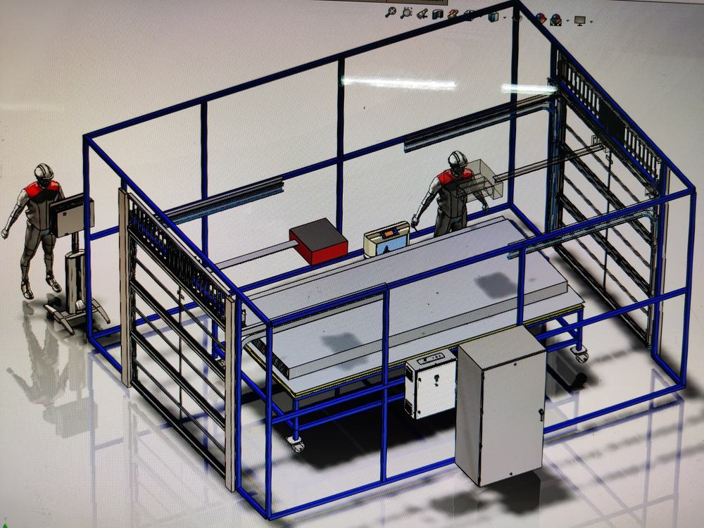 Modelo 3D de la cabina de pruebas con figuras de operador, para verificar alcance y ergonomía antes de fabricar