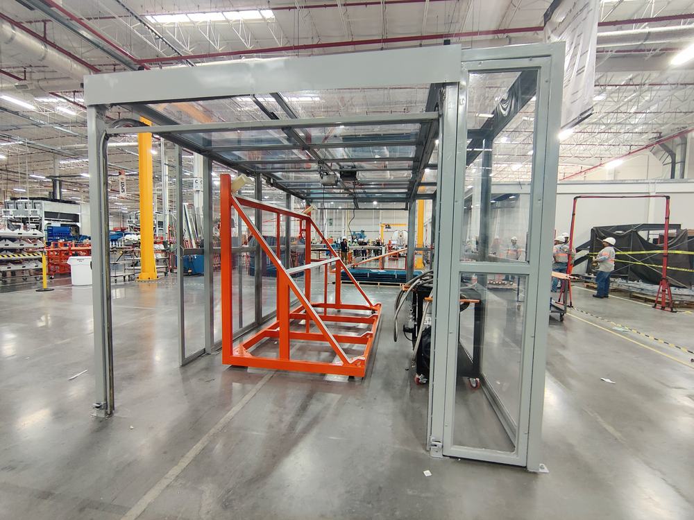 Estructura de la cabina de pruebas siendo fabricada y montada, con perfil de aluminio y paneles